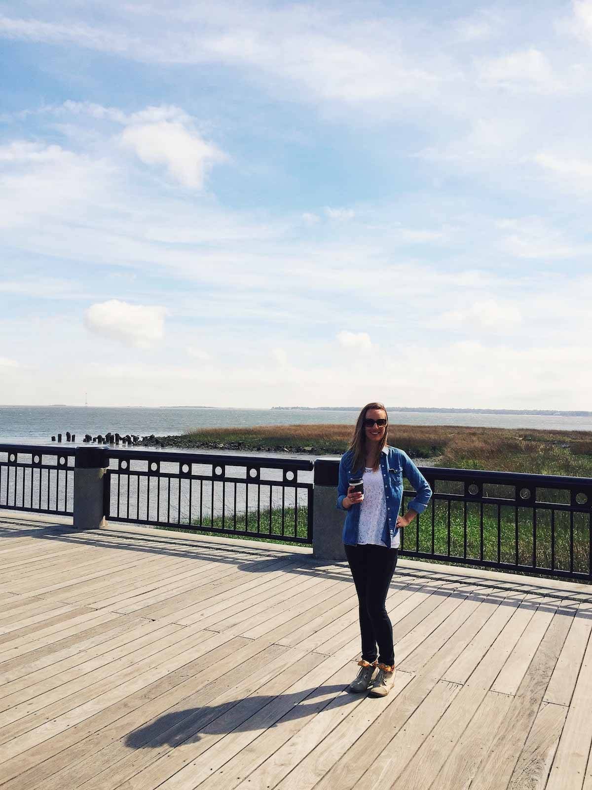 Woman standing on a boardwalk.