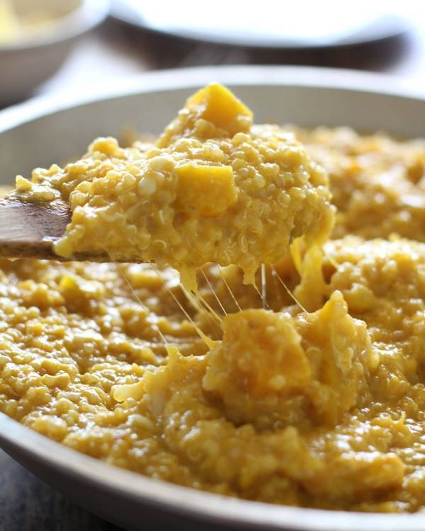 Squash curry quinoa on a wooden spoon.