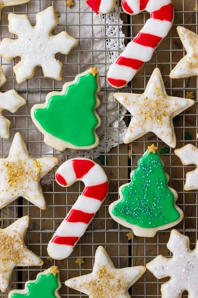 Frosted sugar cookies on a cooling rack.