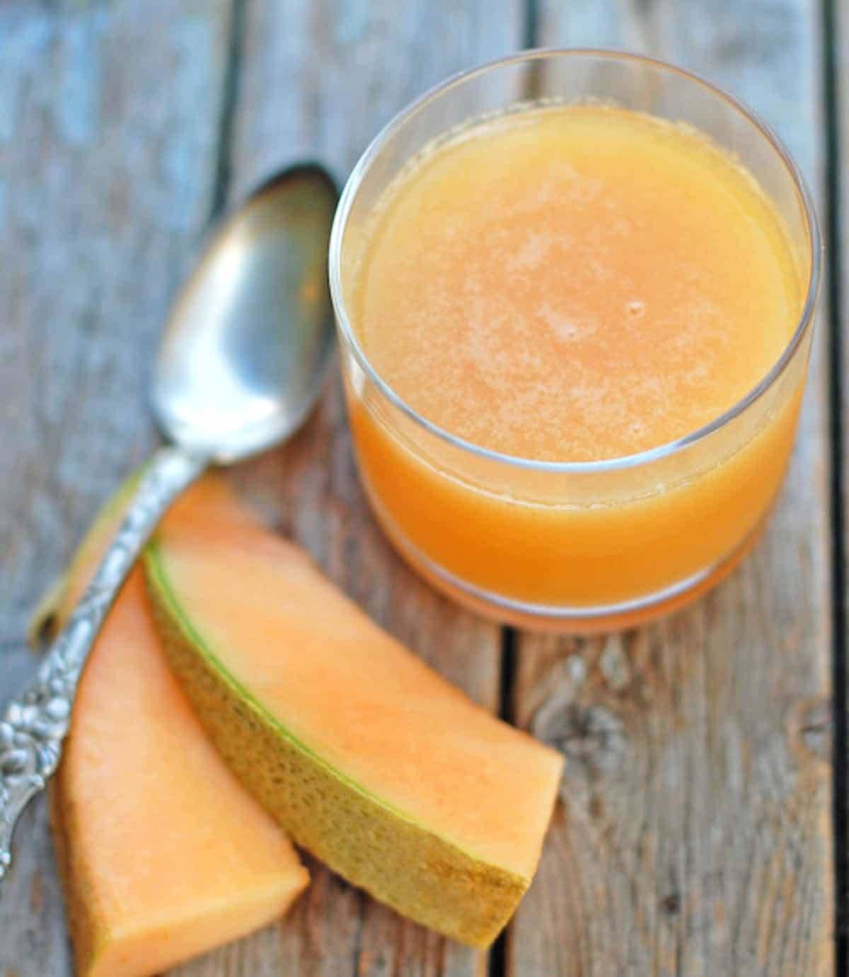 Ginger Melon Chiller in a glass with cantaloupe and a spoon.