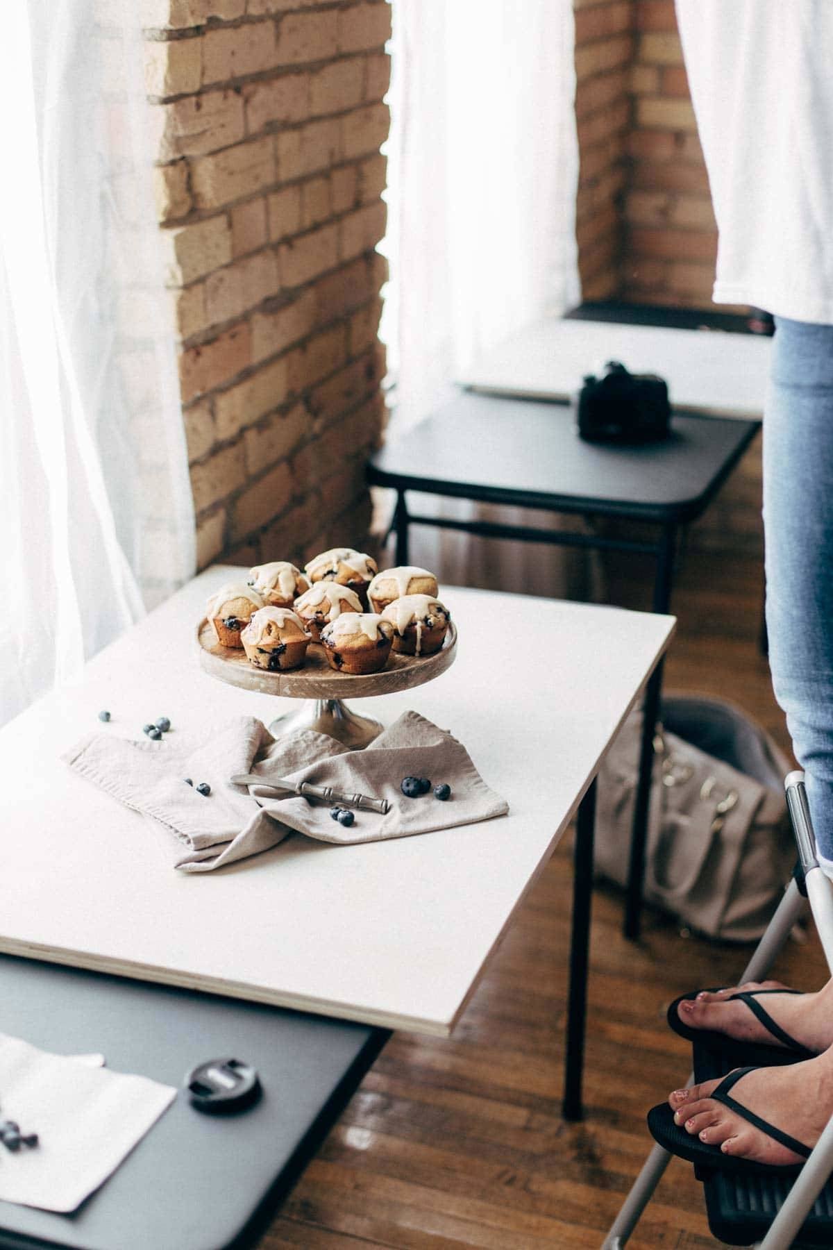 Cake stand with muffins on a table.