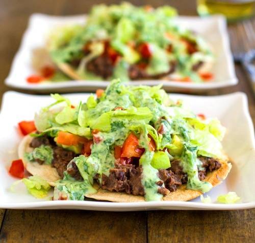 Black bean tostadas drizzled with a homemade healthy cilantro sauce.