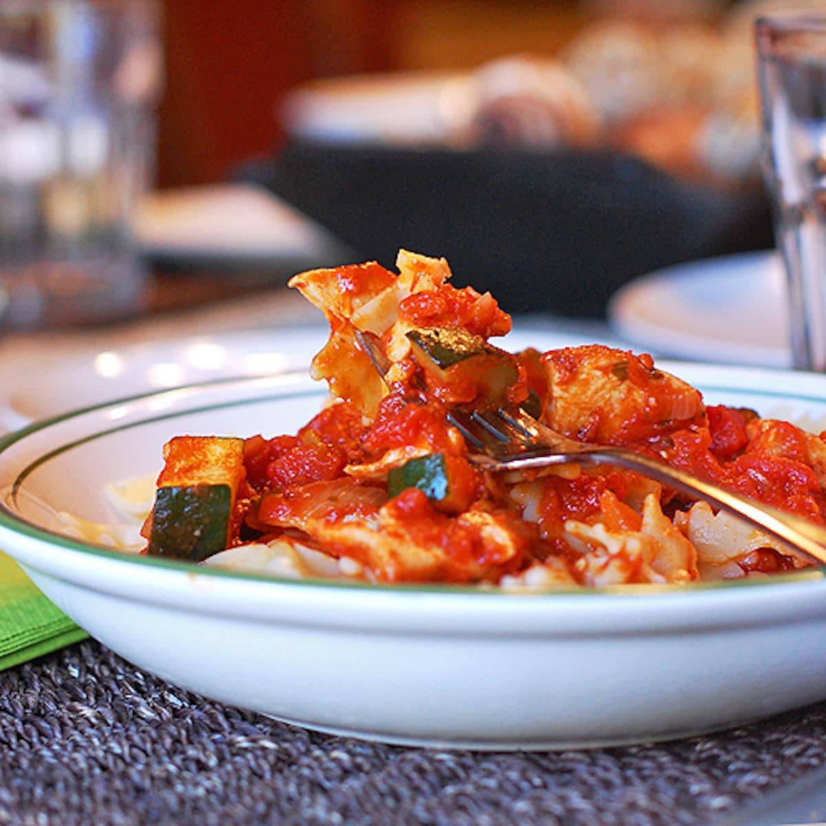 Chicken zucchini pasta in a bowl with a fork.